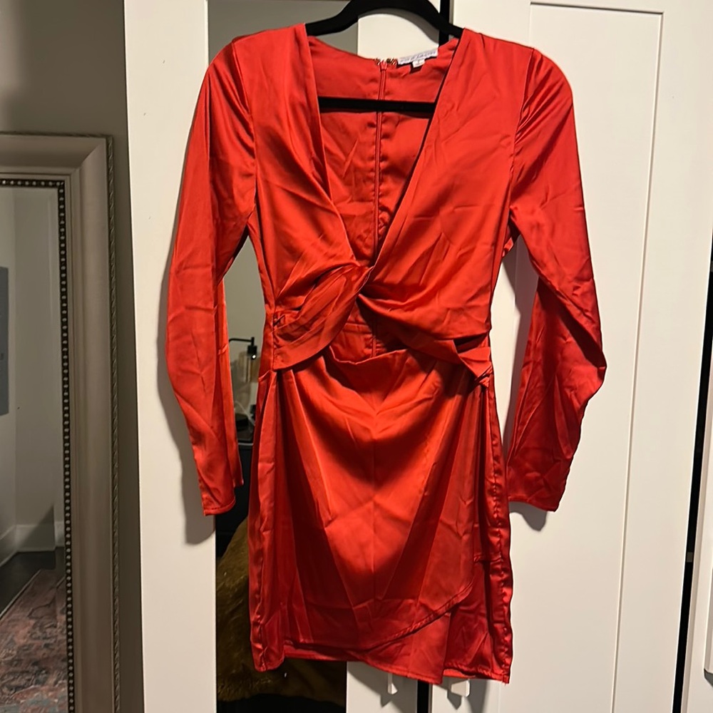 Wrap dress, zip closure. Exposed mid section.